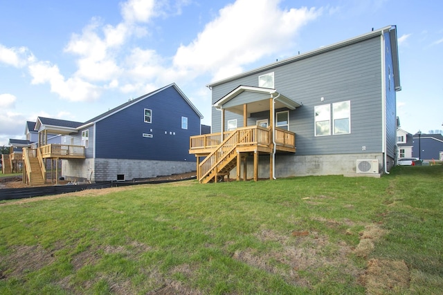 rear view of house with ac unit, a lawn, and a deck