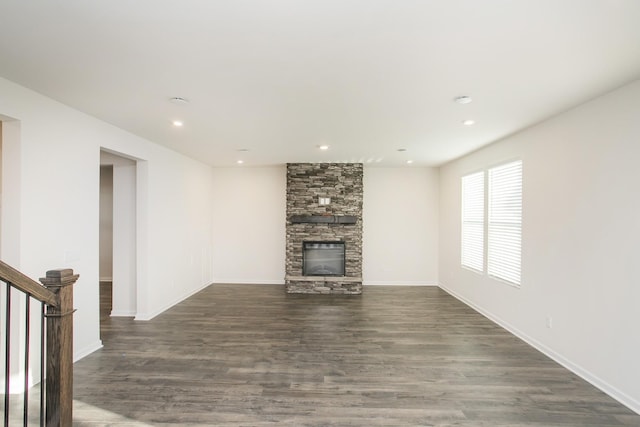 unfurnished living room featuring dark hardwood / wood-style floors and a fireplace