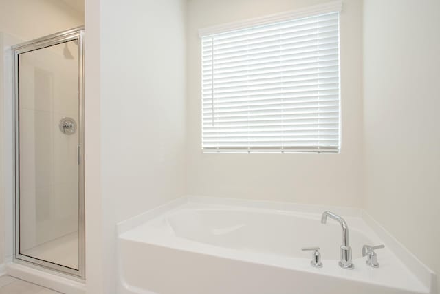 bathroom featuring plus walk in shower