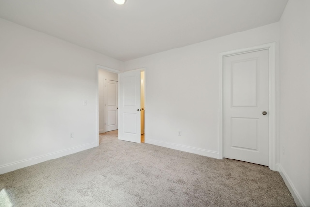 unfurnished room with light colored carpet