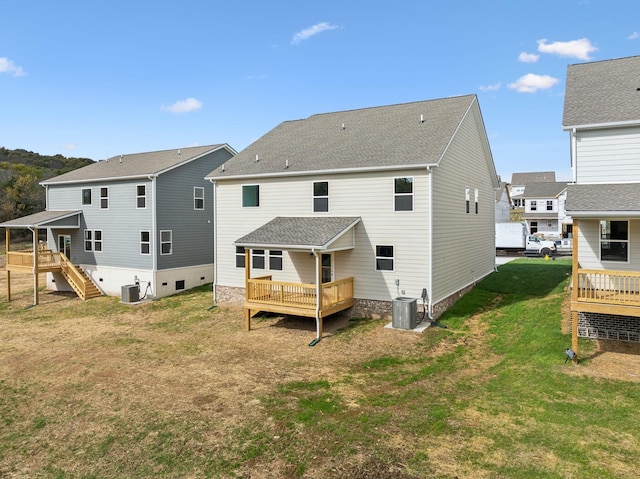 back of property featuring a wooden deck, a yard, and central air condition unit