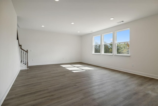 spare room with dark wood-type flooring