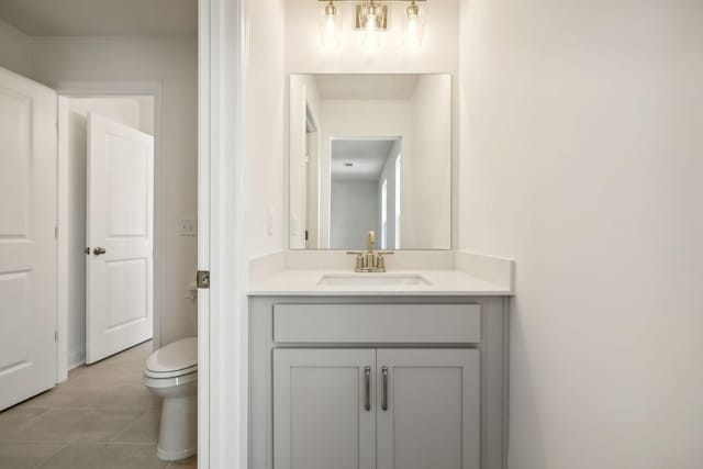 bathroom featuring vanity, toilet, and tile patterned flooring