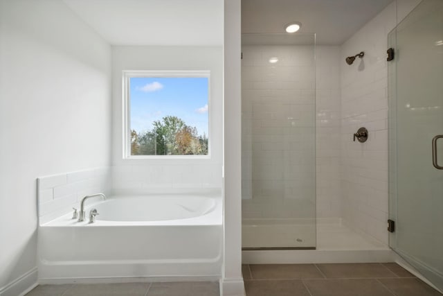 bathroom featuring tile patterned flooring and separate shower and tub