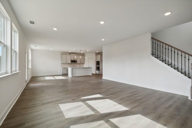 unfurnished living room with hardwood / wood-style flooring