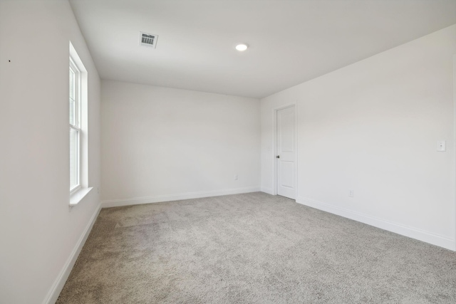 carpeted spare room with plenty of natural light