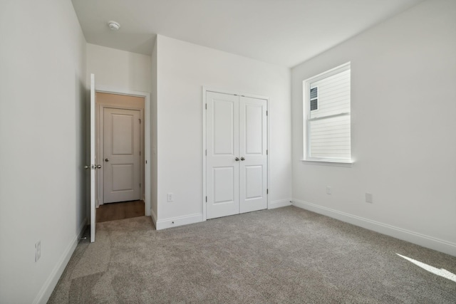 unfurnished bedroom with a closet and carpet