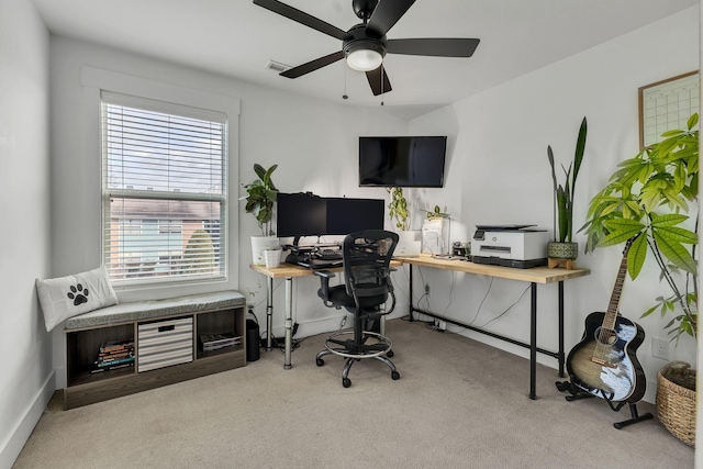 carpeted office featuring ceiling fan