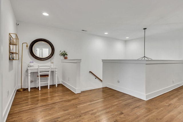 hallway featuring hardwood / wood-style flooring