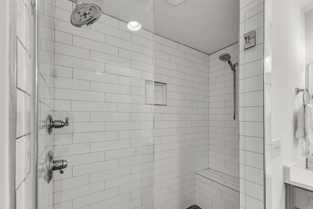 bathroom with a tile shower