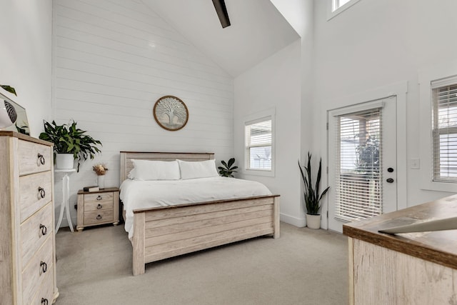 bedroom featuring ceiling fan, light carpet, access to exterior, and high vaulted ceiling