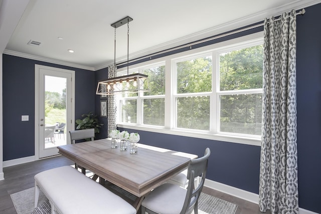 dining space with crown molding and dark hardwood / wood-style floors