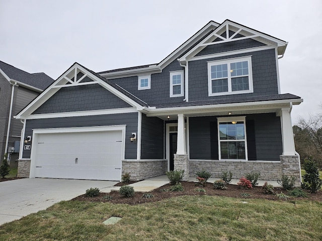 craftsman-style house with a garage, a front lawn, and a porch