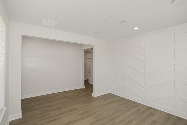 unfurnished room with dark hardwood / wood-style flooring