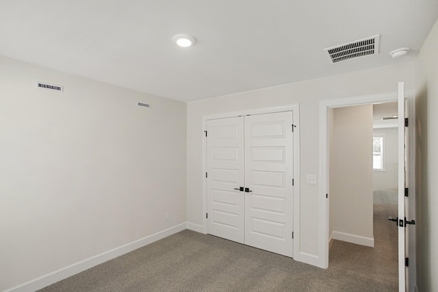 unfurnished bedroom featuring a closet and carpet flooring