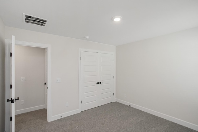 unfurnished bedroom featuring carpet floors and a closet