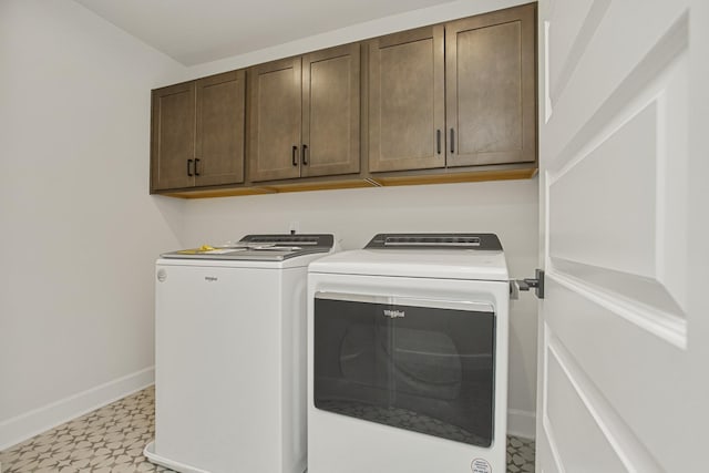 laundry room featuring cabinets and washer and dryer