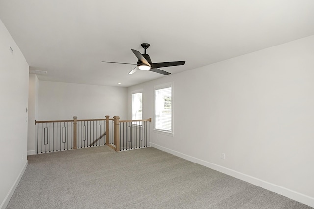 carpeted spare room with ceiling fan