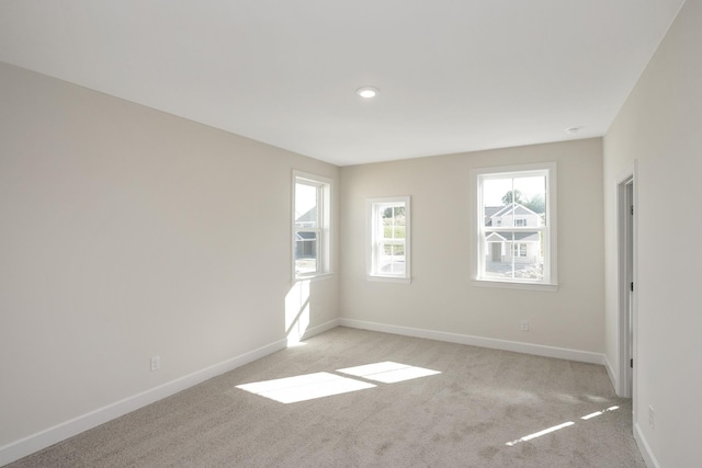 spare room with light colored carpet