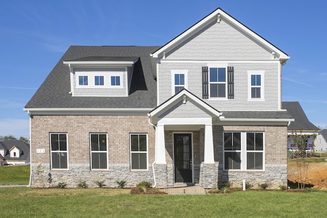 craftsman inspired home with a front lawn