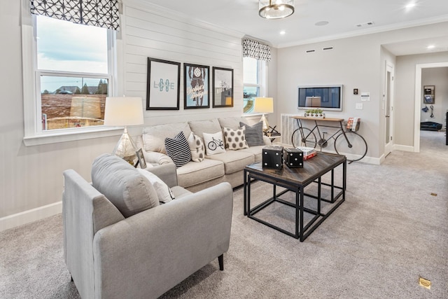 living room featuring ornamental molding, wooden walls, and light carpet