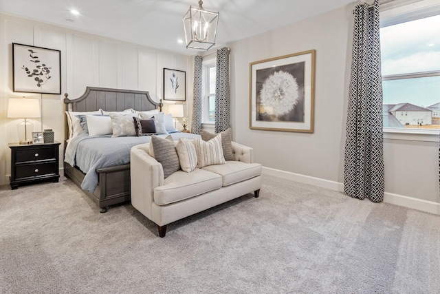 carpeted bedroom with a notable chandelier