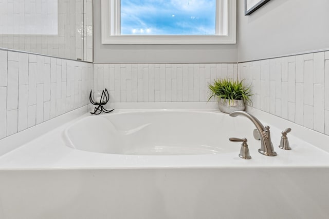 bathroom with a tub to relax in