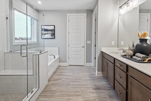 bathroom featuring vanity and plus walk in shower