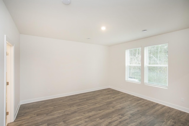 empty room featuring dark hardwood / wood-style flooring