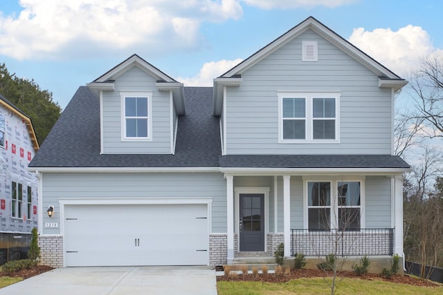 view of front of property with a garage and covered porch