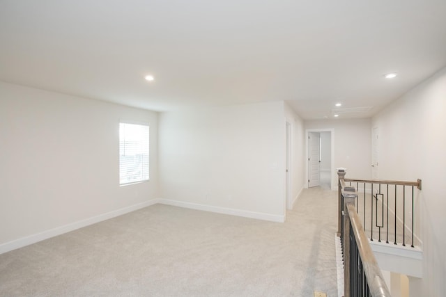 hallway featuring light colored carpet