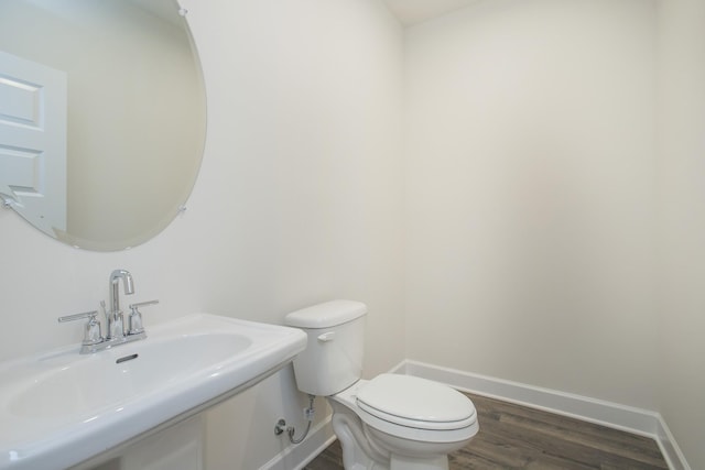 bathroom featuring hardwood / wood-style flooring, sink, and toilet