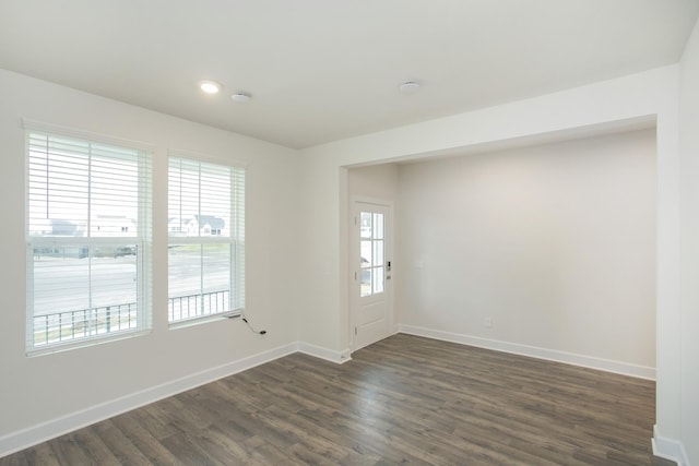 spare room with dark wood-type flooring