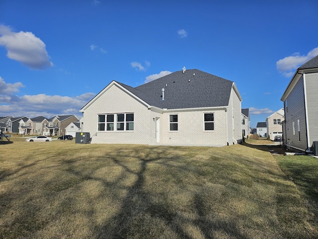 rear view of property featuring a lawn