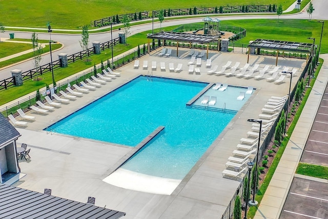 view of pool with a yard, a pergola, and a patio area