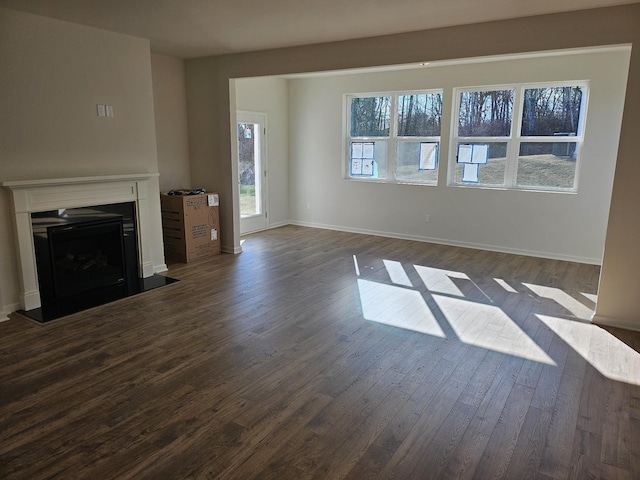 unfurnished living room with dark wood-type flooring