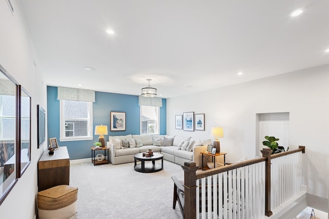 living room featuring carpet floors and a chandelier