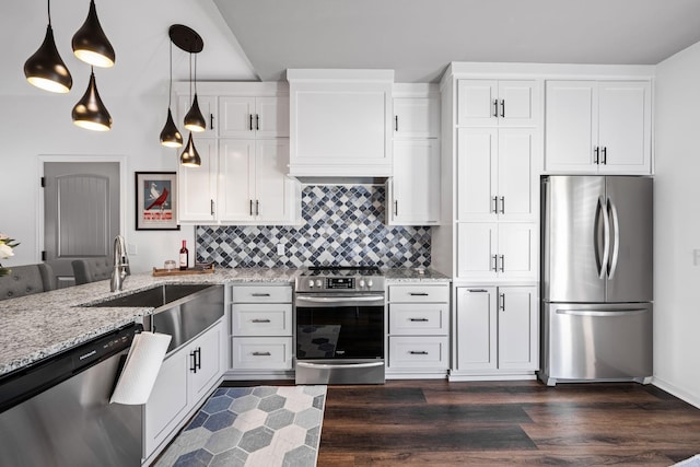 kitchen featuring sink, light stone counters, pendant lighting, stainless steel appliances, and white cabinets