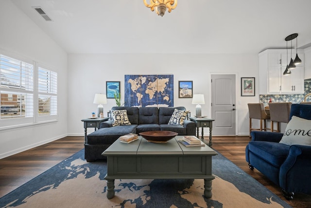 living room featuring lofted ceiling and dark wood-type flooring