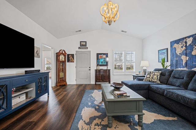 living room featuring dark wood-type flooring, lofted ceiling, and a notable chandelier