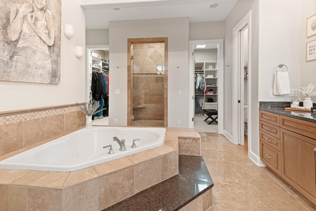 bathroom featuring vanity and plus walk in shower