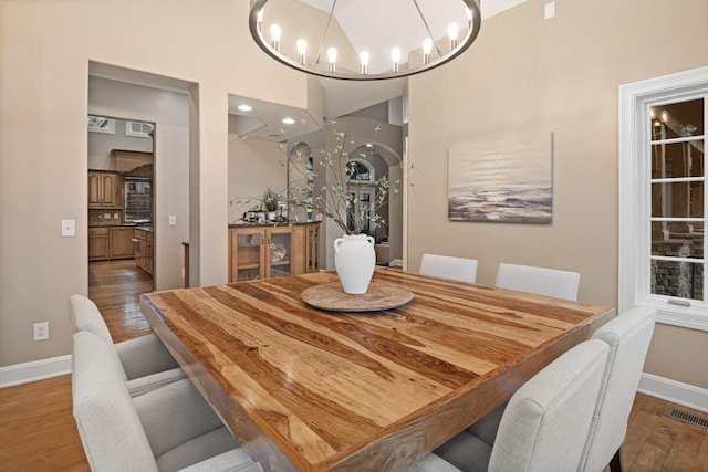 dining room featuring hardwood / wood-style flooring and a notable chandelier