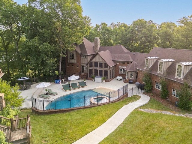 view of pool with a patio area and a lawn