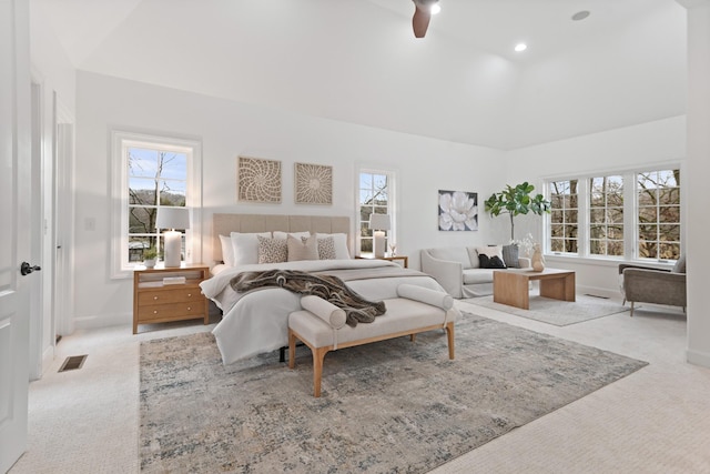 carpeted bedroom featuring ceiling fan and multiple windows