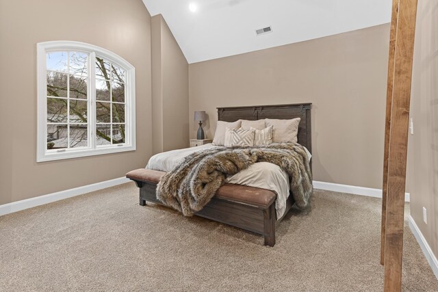 carpeted bedroom featuring lofted ceiling