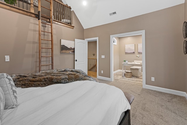 carpeted bedroom featuring ensuite bathroom and high vaulted ceiling