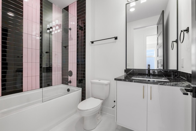 full bathroom featuring vanity, tiled shower / bath combo, and toilet