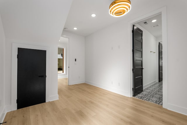 spare room featuring light hardwood / wood-style flooring