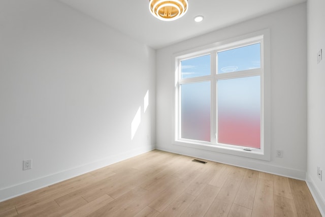 empty room with light hardwood / wood-style floors