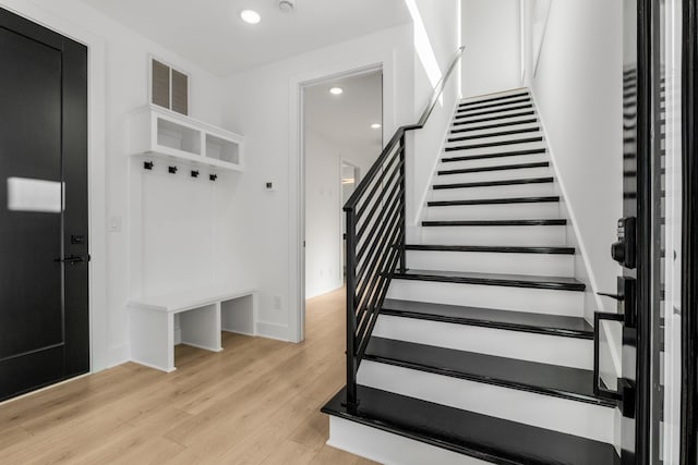 stairway with hardwood / wood-style floors